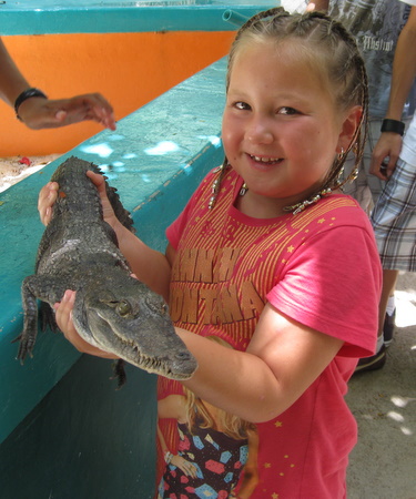 Mika holding a crocodile